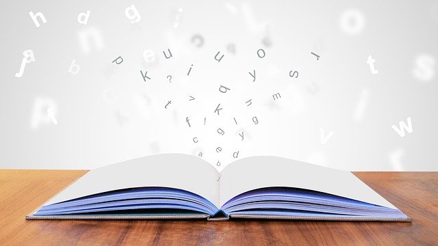 Open book with letters floating